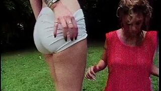 Lesbian babes shove huge toys in their holes outdoors