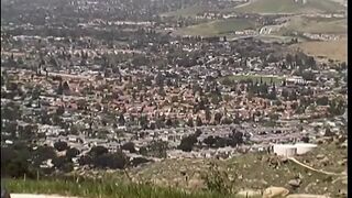 Brunette whore is fucking busty blonde's ass with a dildo by the pool