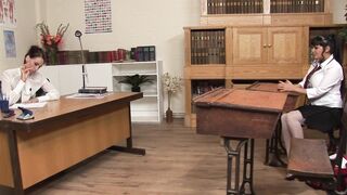 Slender slut moans while lesbian fucks her with a dildo on a desk - 1 image